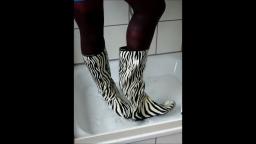 Jana write on fill and messy her zebra rubber boots in the shower trailer