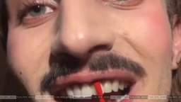 Nothing unusual, just a man painting his teeth with red varnish - the color of his lipstick
