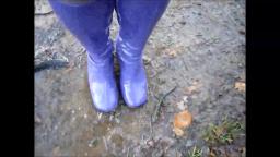 Jana walks with her shiny purple gogo boots in the forest puddle and mud trailer