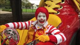 Ronald Mcdonald goes for a joy ride in his giant clown shoe car