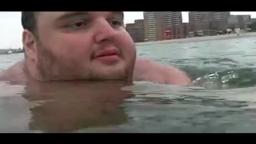 man swimming in an ocean in july 2015