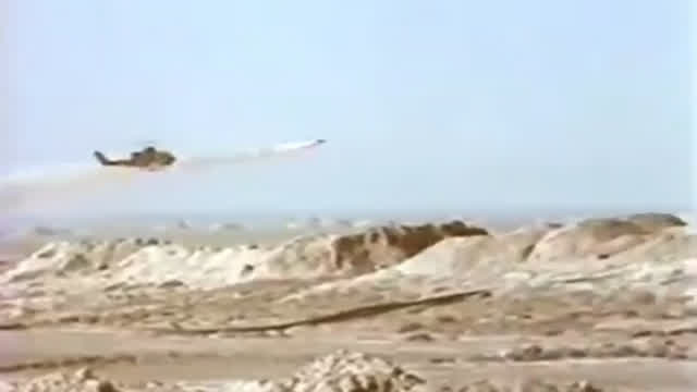 Iranian AH-1 destroys an Iraqi tank in the distance