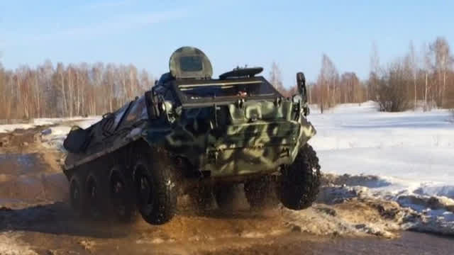 A girl and an armored personnel carrier.