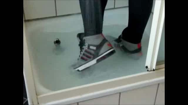 Jana wets her gray Adidas Hardcourt and squeaks with them in the shower trailer