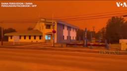 Looks like night in the daytime: Surreal video of smog from 240 wildfires turning Canadian skies r