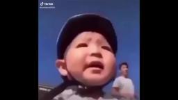 Asian kid falls off bike with goofy ahh sound effects