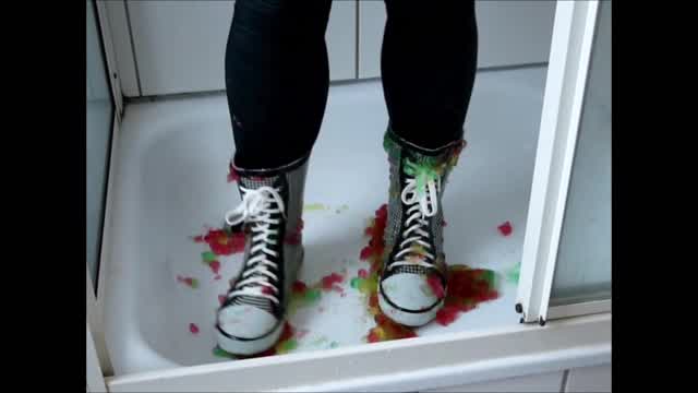 Jana messy her Converse-style rubber boots in jelly and wash them in the shower trailer