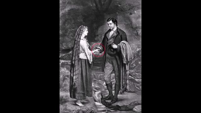 335 Robert Burns sosteniendo un objeto rectangular parecido a un móvil