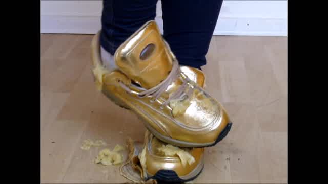 Jana crushes bananas with her golden Buffalo sneakers and messy them with it trailer