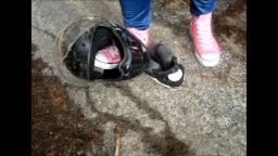 Jana tramples on a motorcycle helmet with her pink chucks trailer