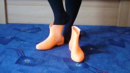 Jana shows her glow in the dark shiny rubber booties orange with black loop