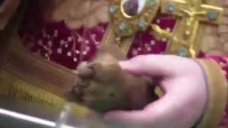 Russian Orthodox Christians drinking holy water from a foot relic of a dead saint