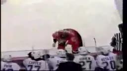 hockey player tries to start fight, slips