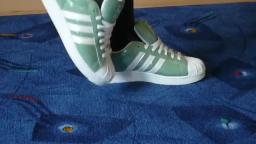 Jana shows her Adidas Superstars green, white