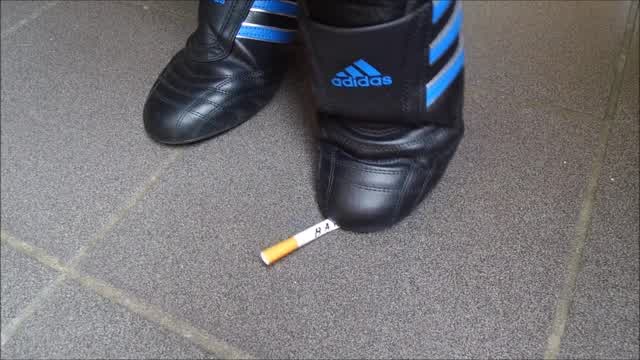 Jana crush cigarettes with her Adidas Martial Art SM-II sneakers trailer